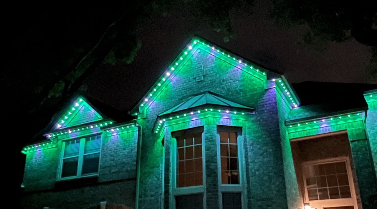 Roofline of a Council Bluffs area home glowing with professionally installed permanent LED lighting