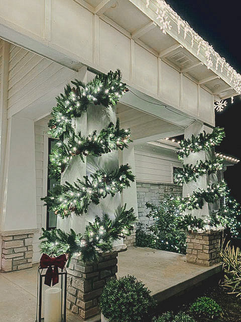 Omaha home glowing with warm white professional christmas lighting after dark